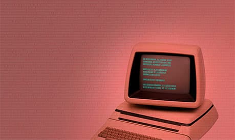An old white computer with a pink background