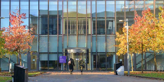 Two AMBS colleagues walking into the AMBS Executive Education centre