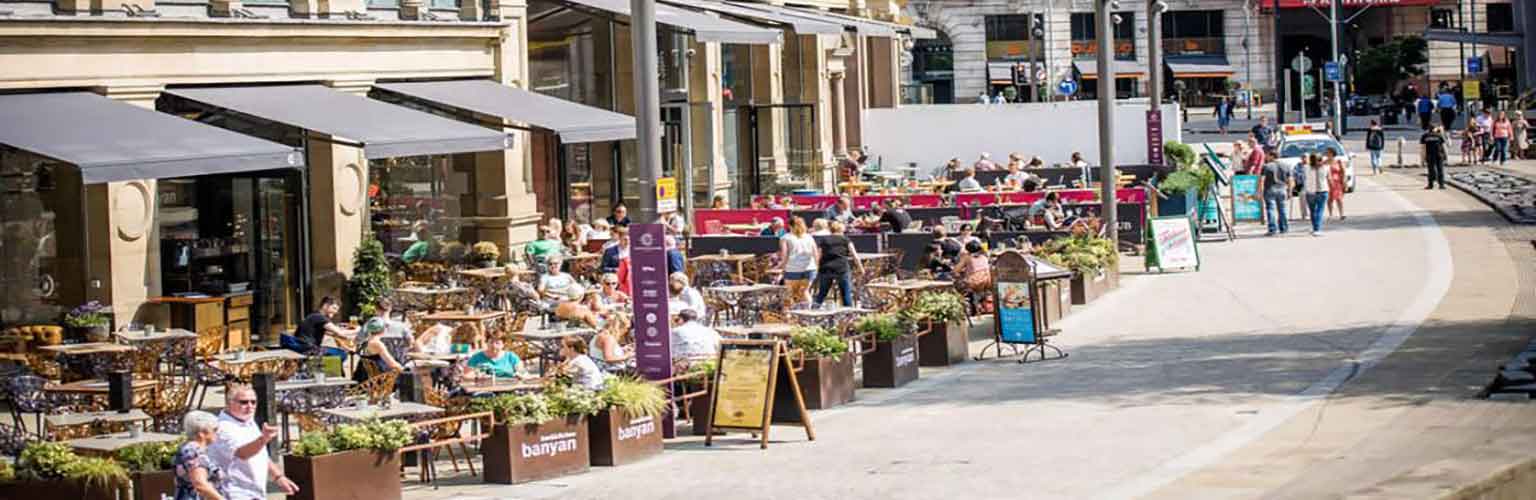 People dining outside the Corn Exchange in Manchester