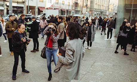 Photographers take photos of a woman on a Milan street