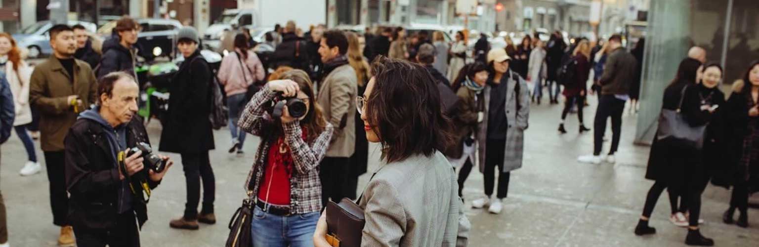 Photographers take photos of a woman on a Milan street