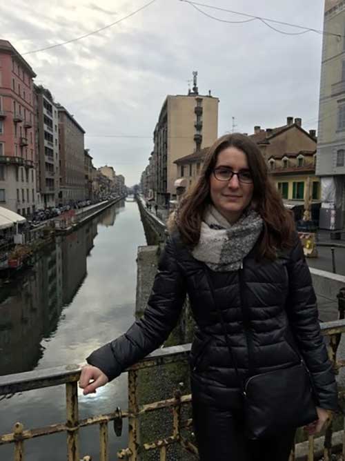 Camille Hanotte standing by a canal in Milan
