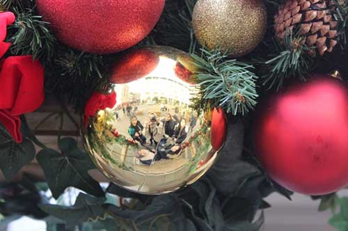 A Christmas bauble with a reflection of Amanda Kusmajaya and her friends