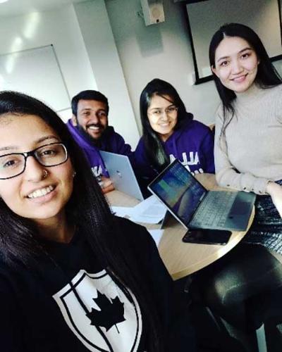 Aditi Verma with three fellow students doing some group work