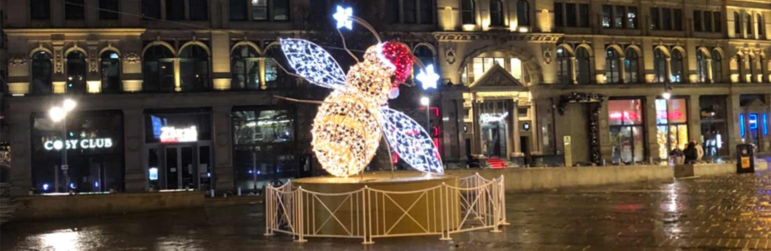 The manchester bee with lights and a santa hat on