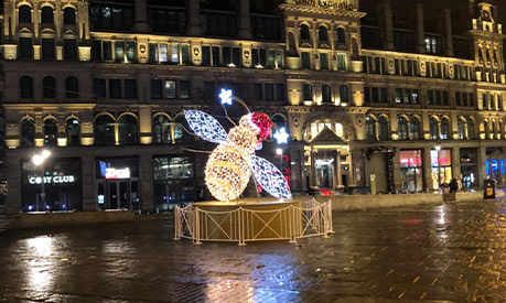 The manchester bee with lights and a santa hat on