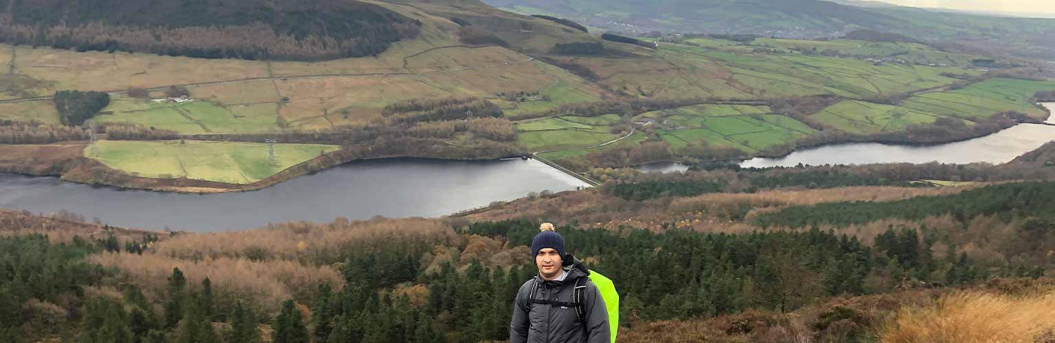 Yury hiking with the lake district in the background