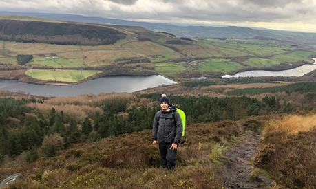 Yury hiking with the lake district in the background