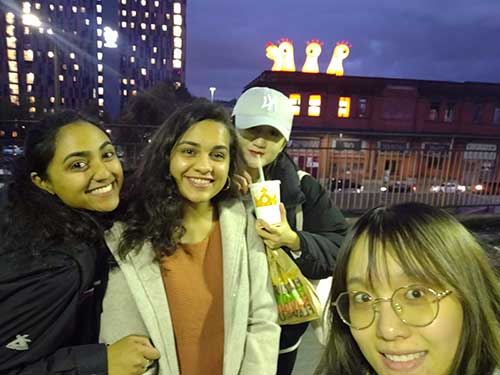 Payal Mehta and 3 friends standing on the platform at Manchester Piccadilly railway station