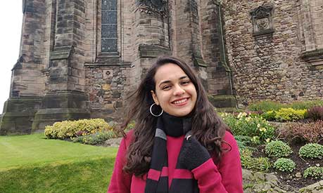 Payal Mehta stood in front of a stone building in Scotland