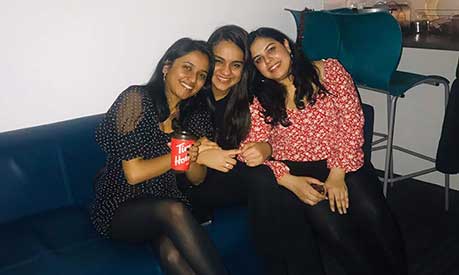 Payal Mehta and two friends sitting on a sofa