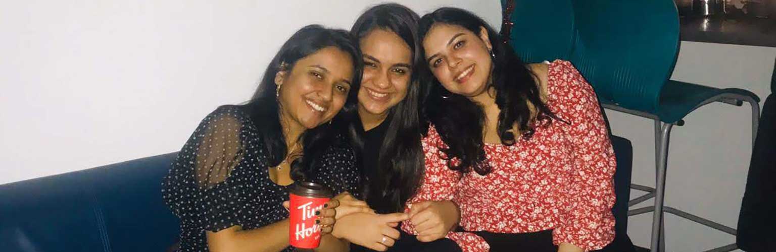 Payal Mehta and two friends sitting on a sofa