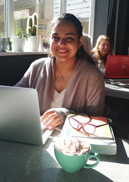 Payal Mehta with her laptop in a cafe