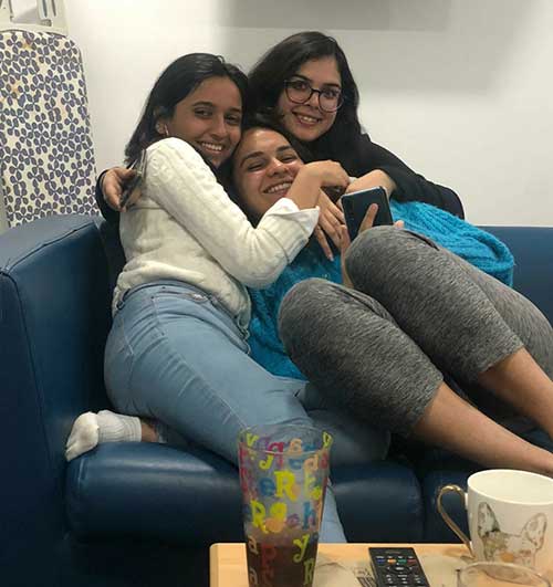 Payal Mehta and two friends sitting on a sofa