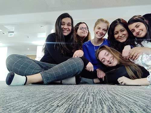 Payal Mehta and a group of friends sitting on the floor