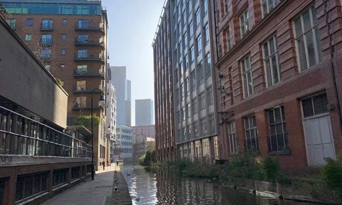 A view of the Deansgate tower from a canal in Manchester