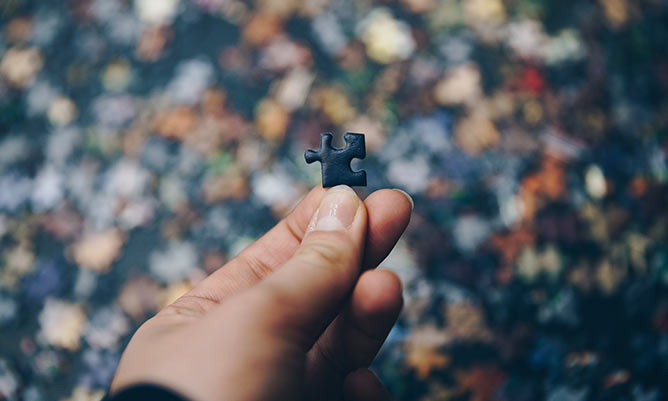 person holding a piece of a jigsaw