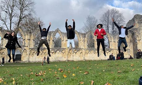 Ashish Agarwal and his friends jumping in the air in York.