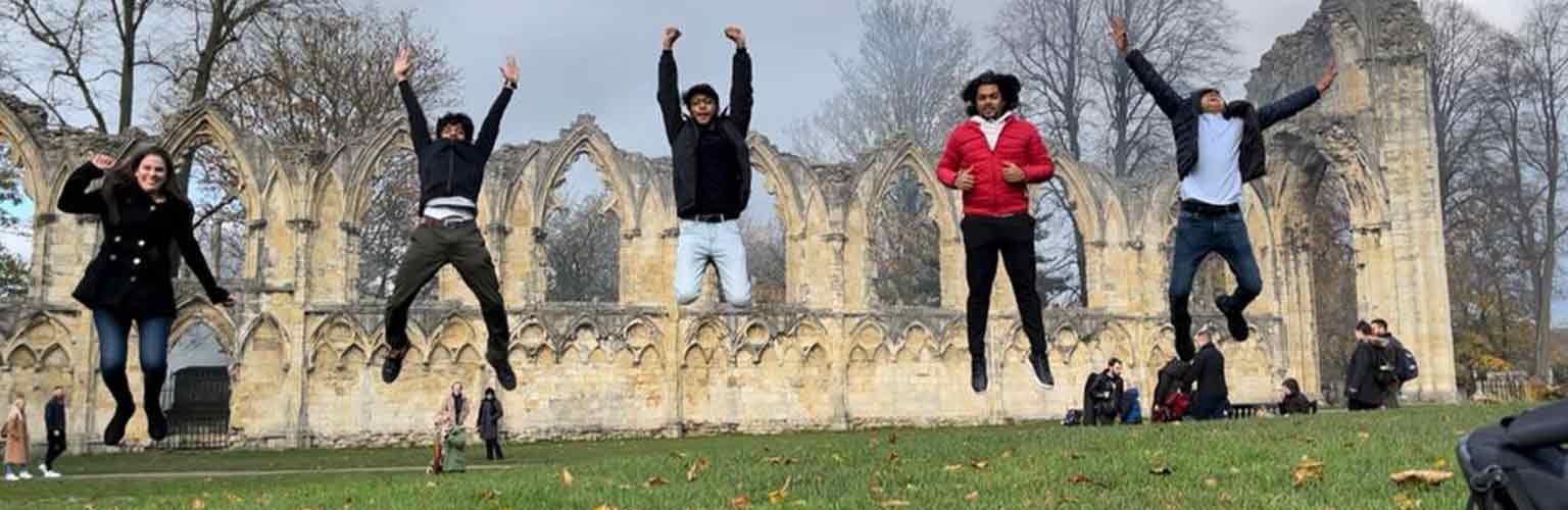 Ashish Agarwal and his friends jumping in the air in York.