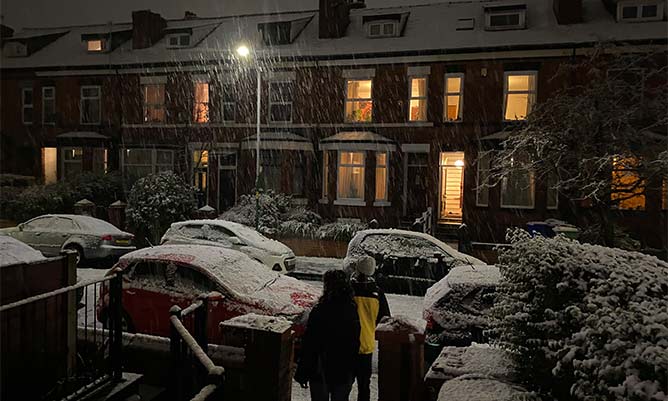 A street in the UK covered in snow at night 