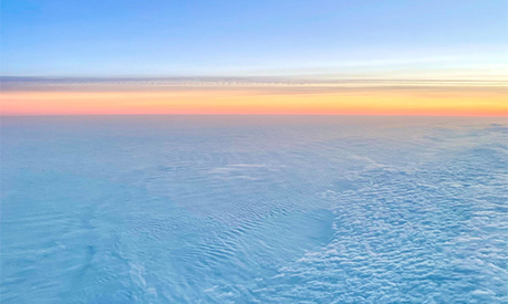 A view of a sunset from an airplane window 