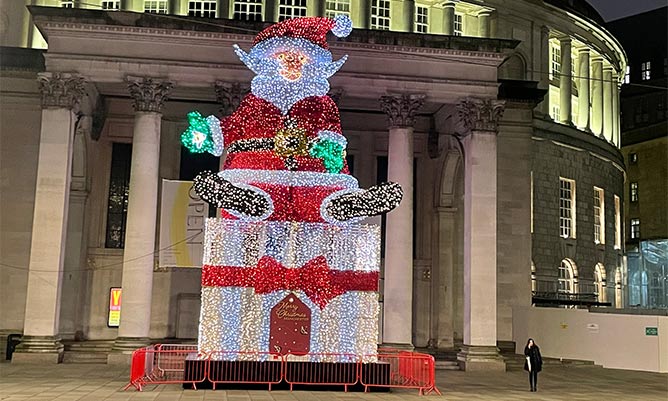 An illuminated santa in front of the Central Library in Manchester