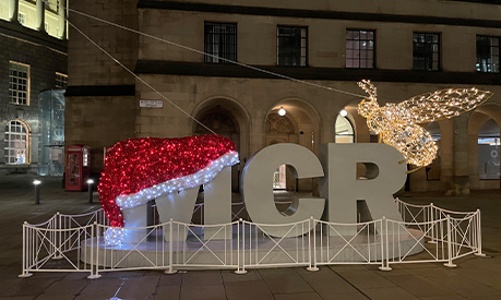 The MCR sign outside Central Library in Manchester with a santa hat on the letter M