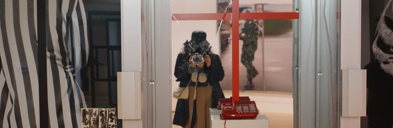 Mariam taking a photo of herself in a store