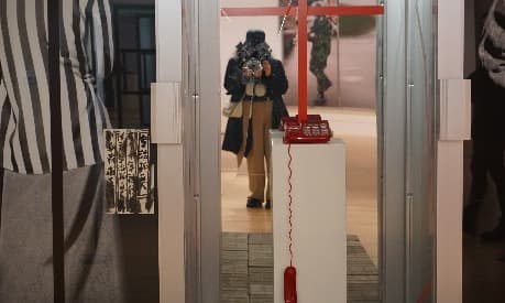 Mariam taking a photo in a window in a store