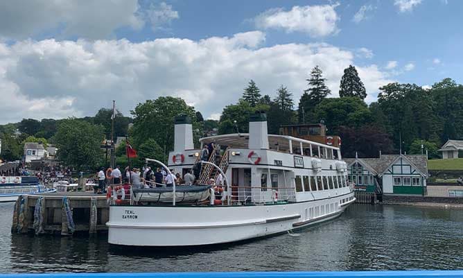 A boat full of people in the lake district 