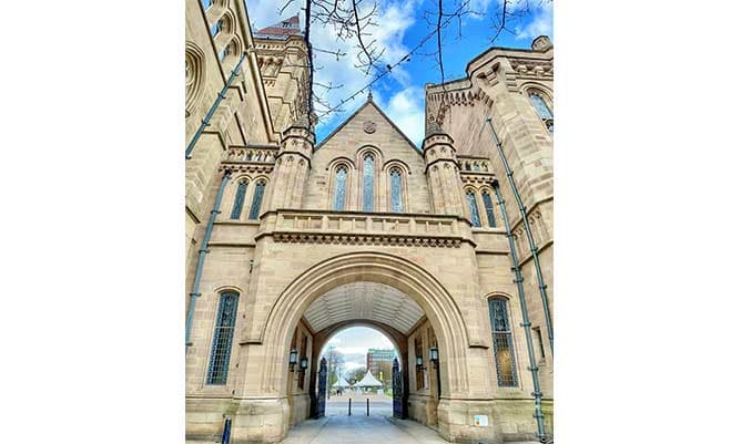 The University of Manchester arch with a blue sky
