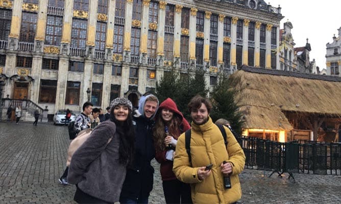 Chloe Softly and her friends outside a building