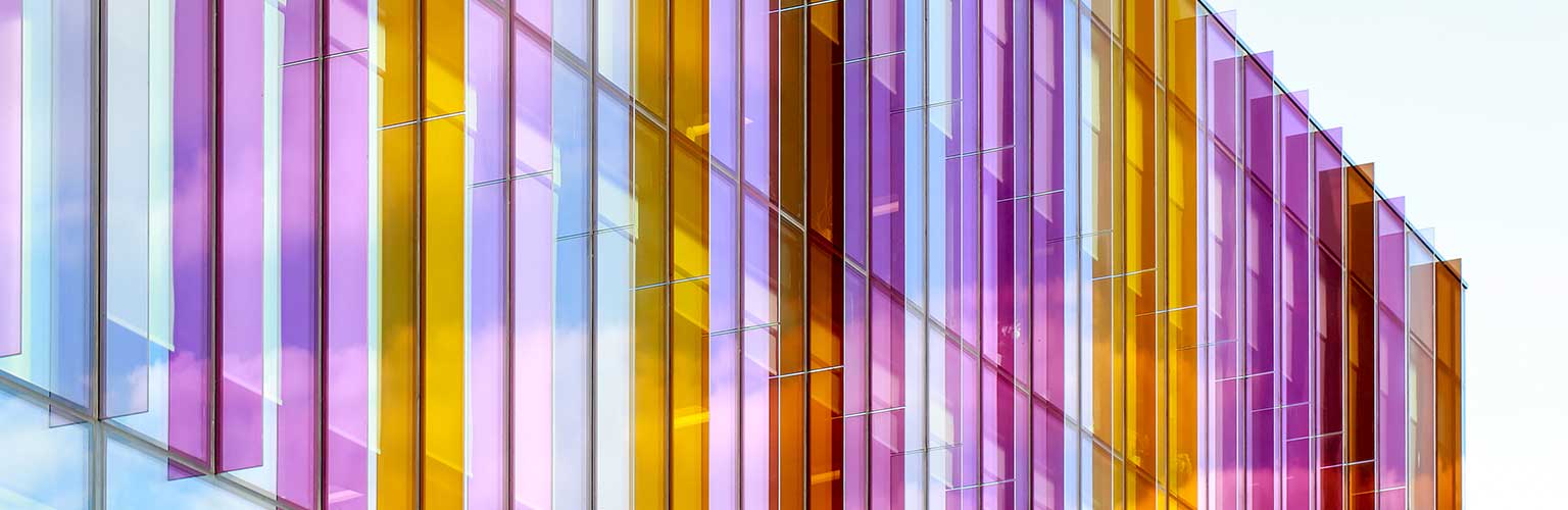A photo of the multicoloured glass fins above the entrance to the Alliance MBS building
