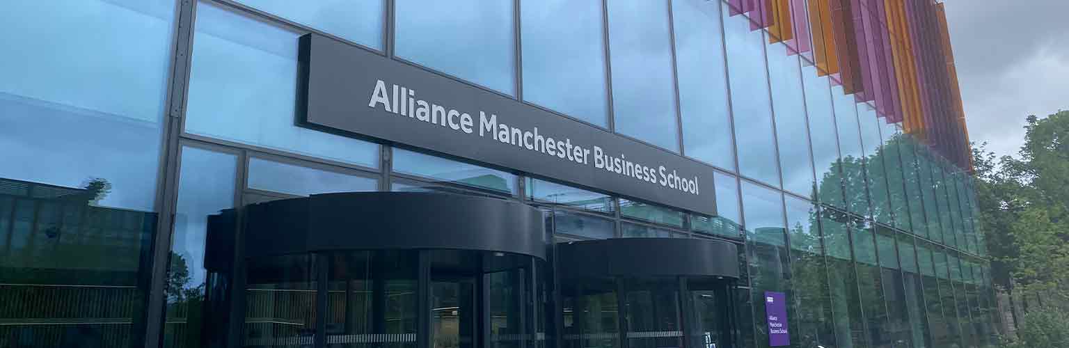 The front of the Alliance Manchester Business School building with grey skies in the background