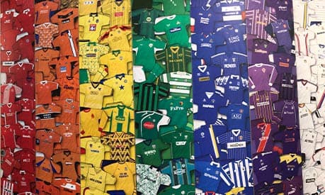 A collection of football shirts forming a rainbow colour from the national football museum