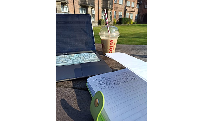 laptop, coffee and notepad on a sunny day