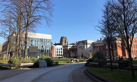 The Alan Gilbert Learning Commons in the sunshine and blue sky in the background