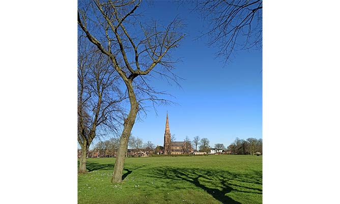 church in the distance of a sunny field