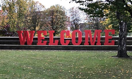 A sign that says 'welcome' in red letters in Deansgate