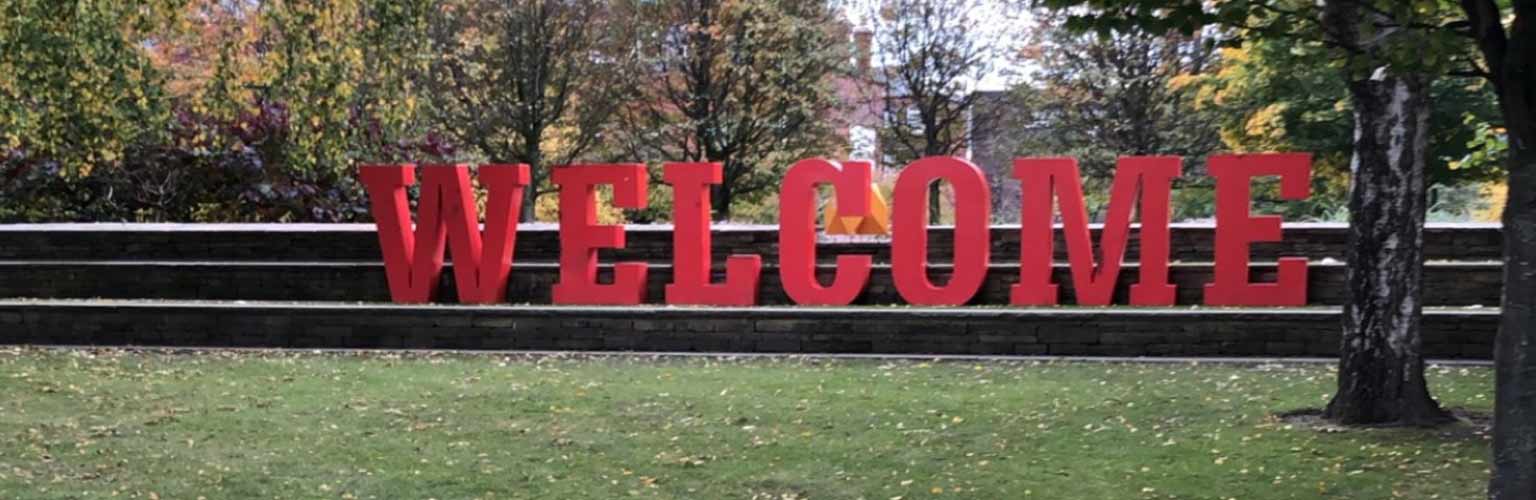 A sign that says 'welcome' in red letters in Deansgate