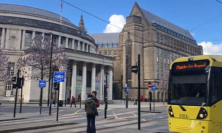 A Manchester Tram on St Peter's Square with the Central Library in the background