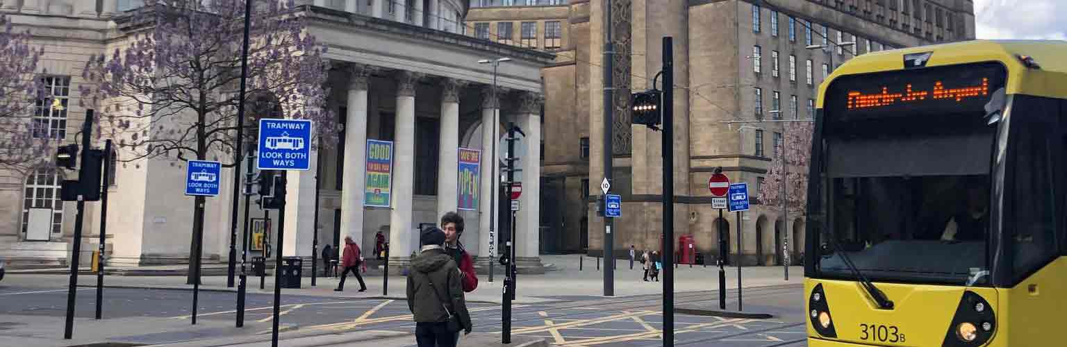 A Manchester Tram on St Peter's Square with the Central Library in the background