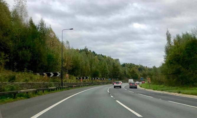 A picture of a motorway in the UK with trees on either side