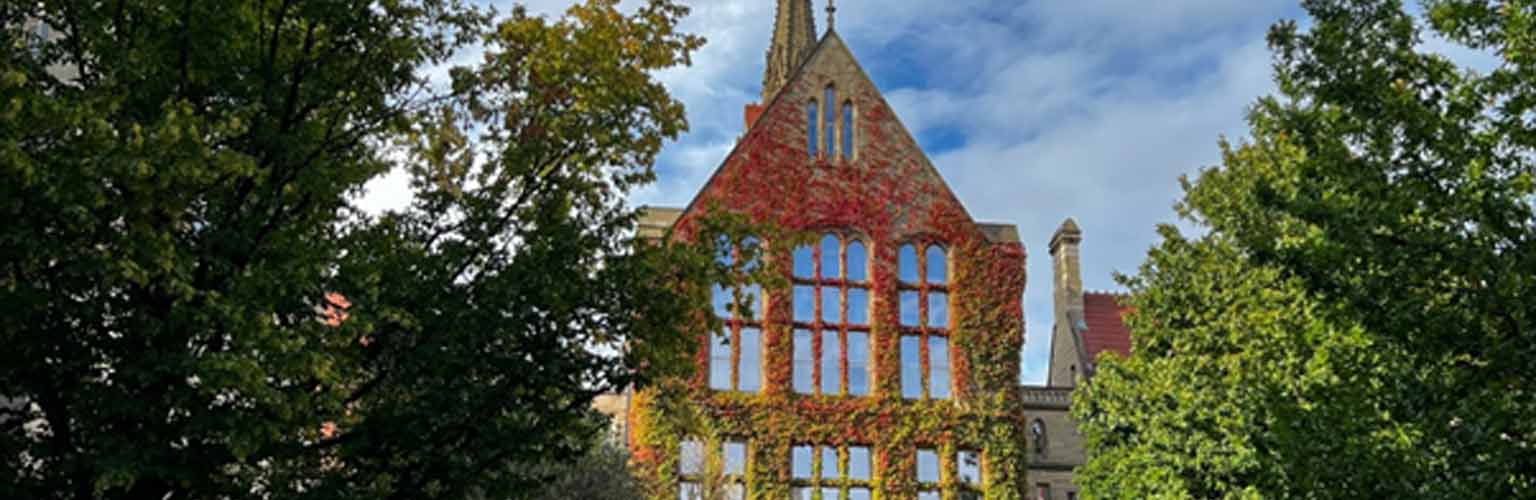 The old quadrangle in the autumn with red leaves