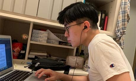 Chi Hong Adam Chan working on a laptop