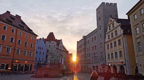 An Old Town square in Germany during the sunset
