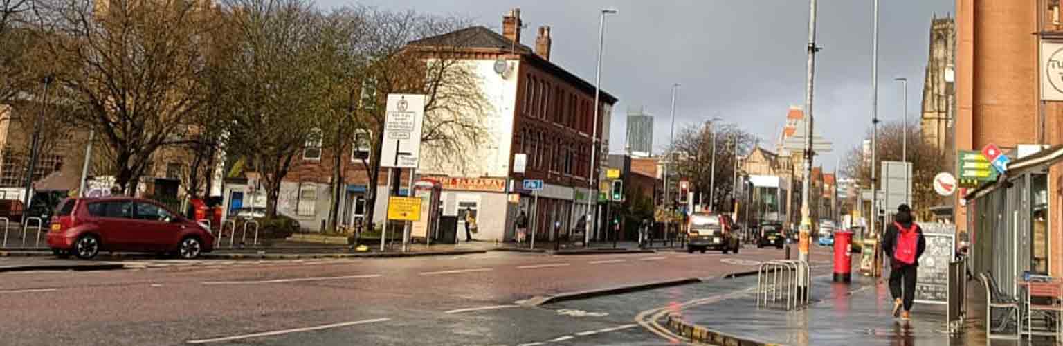 A view down a Manchester road with grey sky