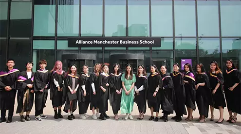 Yitong Zhang celebrating graduating with her MSc Accounting cohort outside the Alliance Manchester Business School
