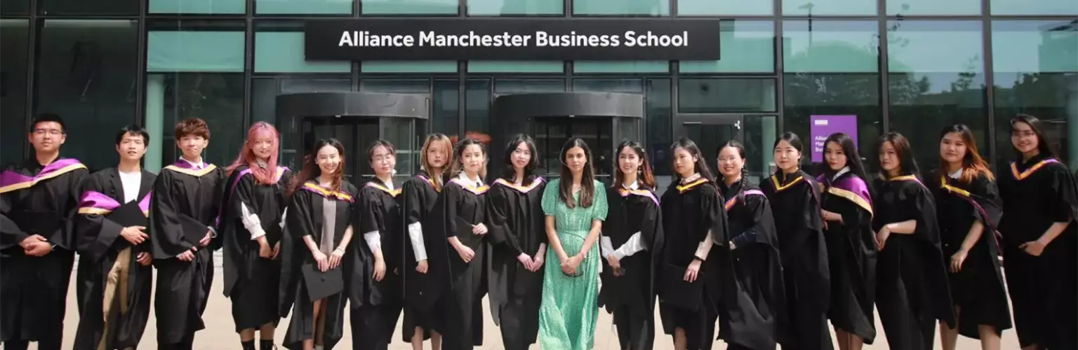 Yitong Zhang celebrating graduating with her MSc Accounting cohort outside the Alliance Manchester Business School