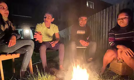 Ashish Agarwal and his friends sitting around a small camp fire